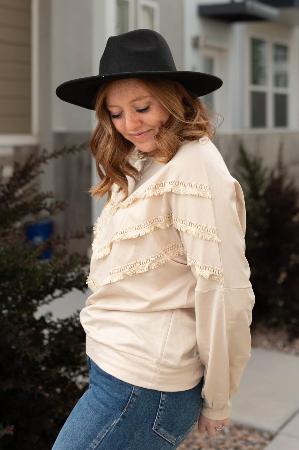 Side view of a beige pullover