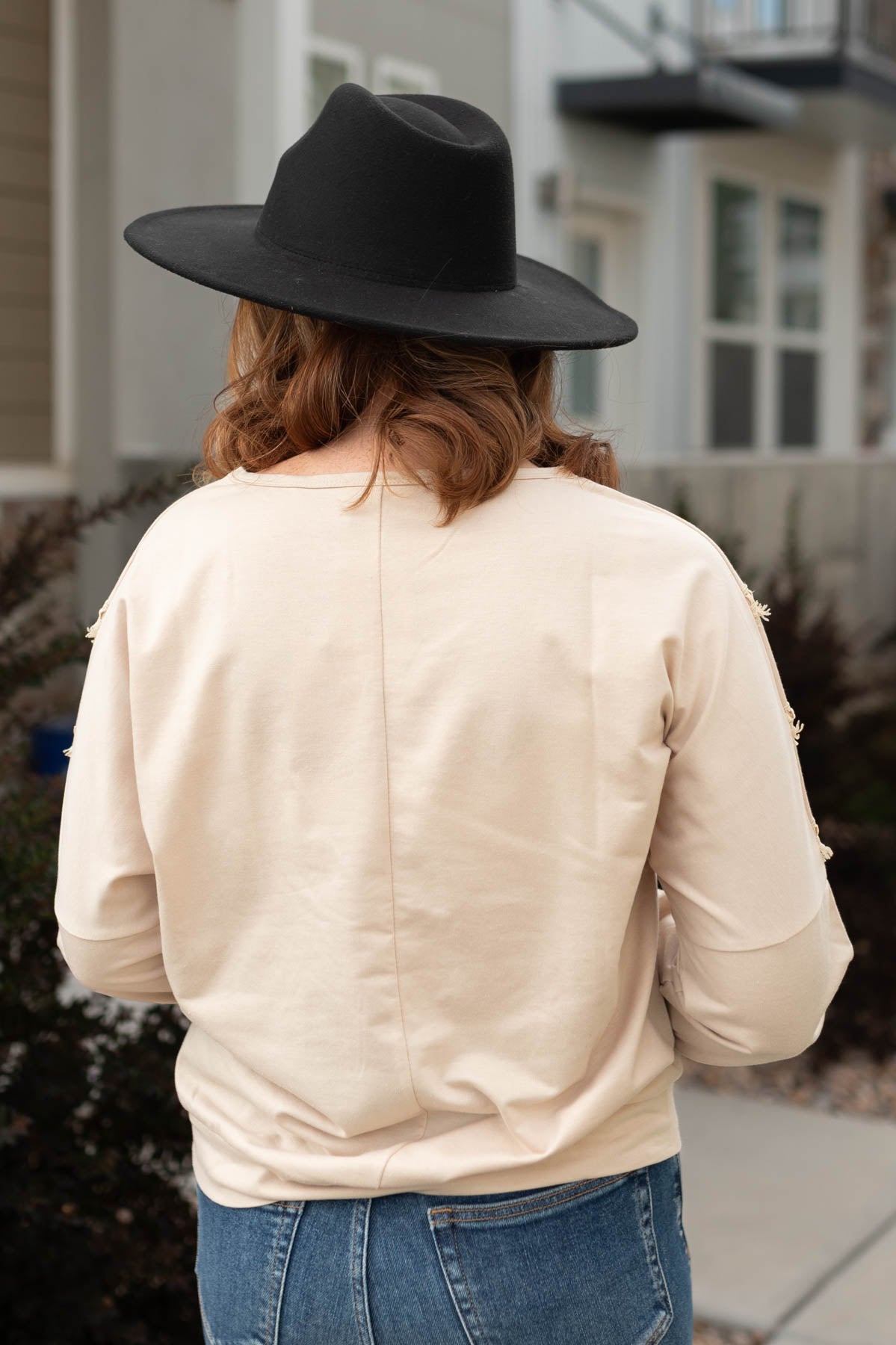 Back view of a beige pullover