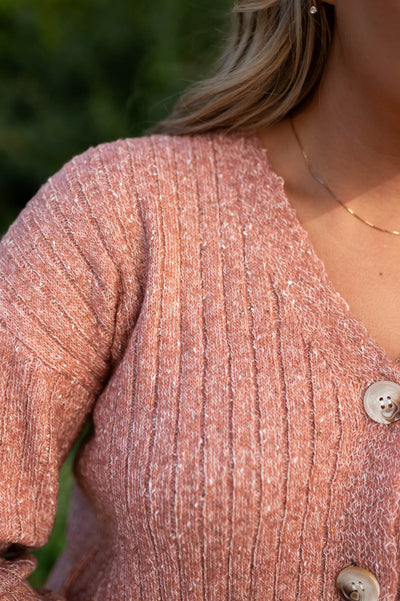 Close up of the neckline of a bush cardigan