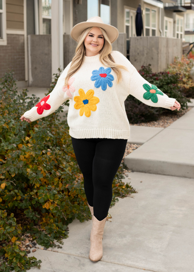 Plus size cream flower sweater with long sleeves and bright flowers