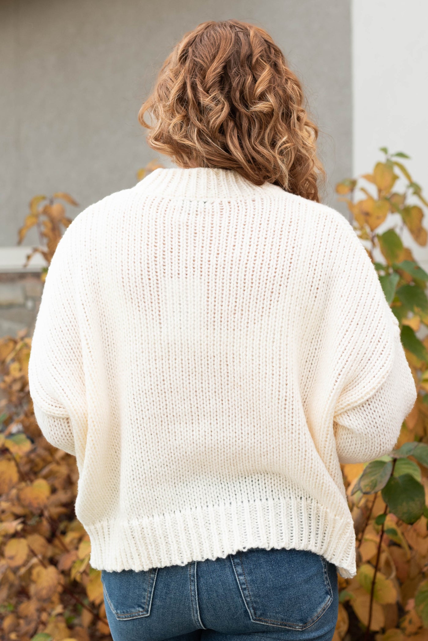 Back view of the cream flower sweater