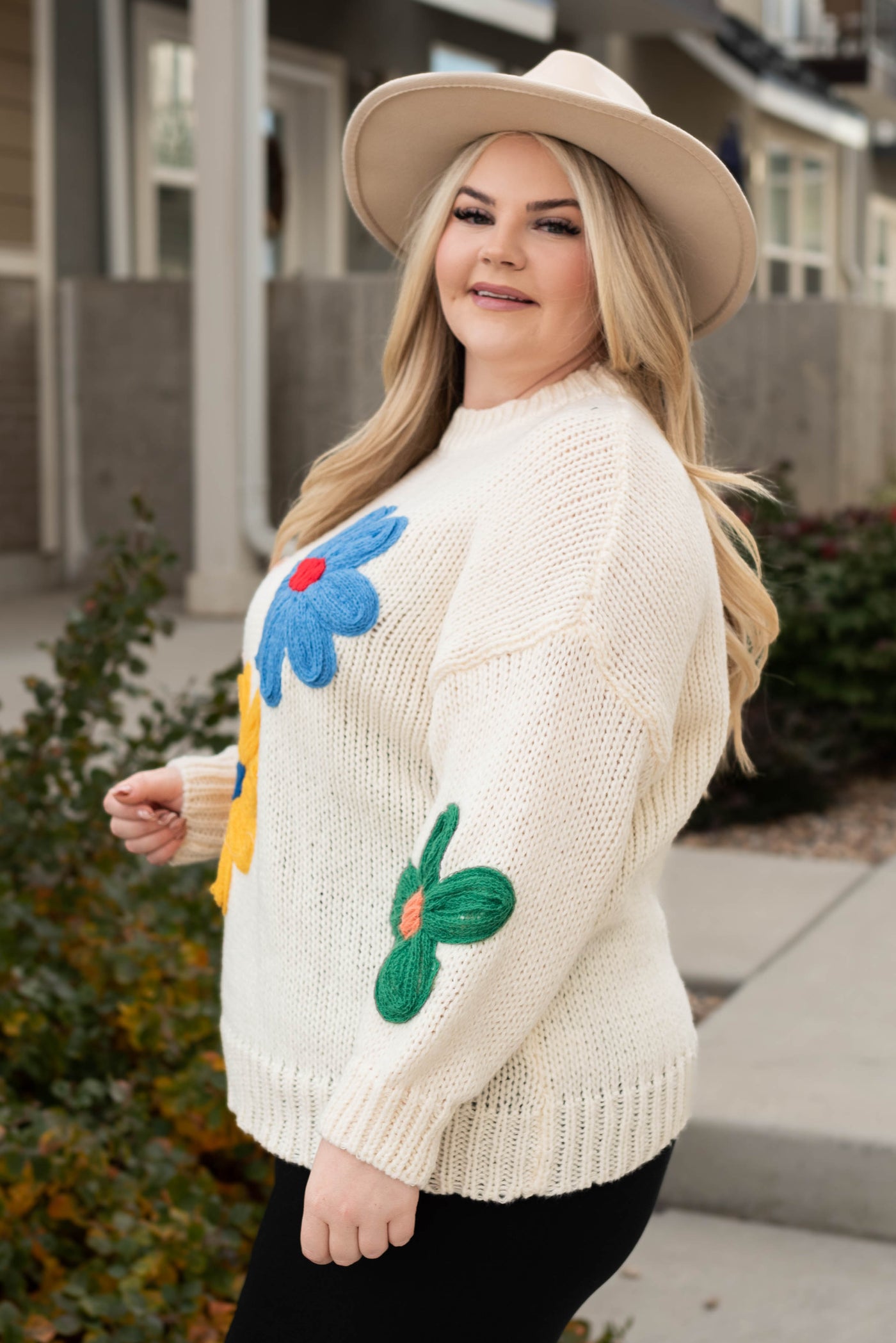 Side view of the plus size cream flower sweater