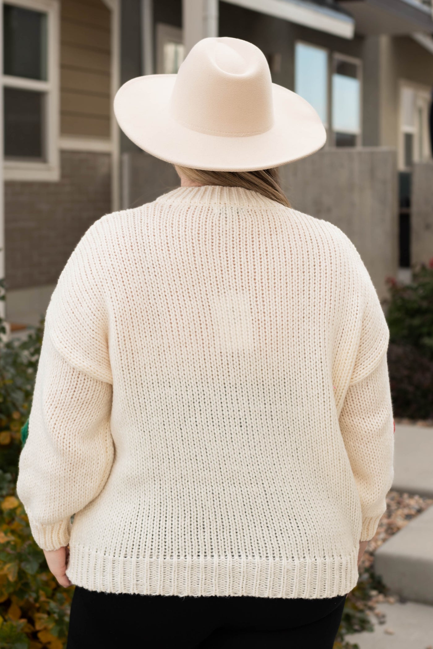 Back view of the plus size cream flower sweater
