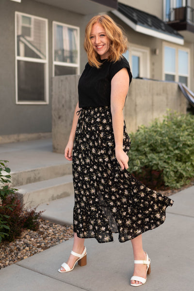 Cap sleeve black top with black floral skirt that is sold separately