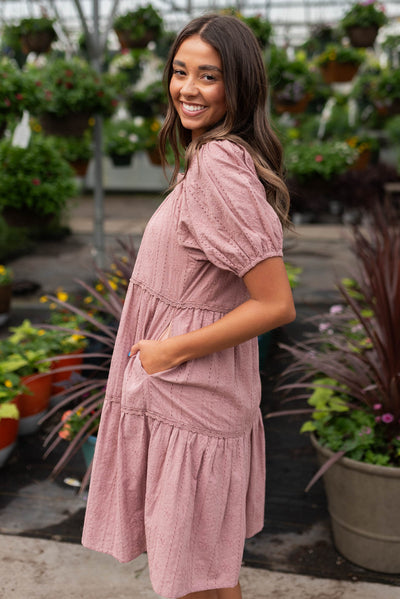 Side view of the dusty mauve embroidered dress with pockets