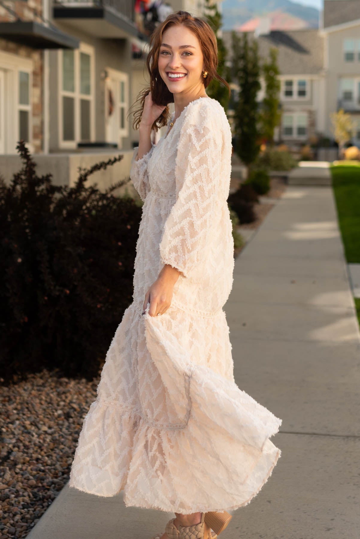 Side view of a long sleeve cream dress