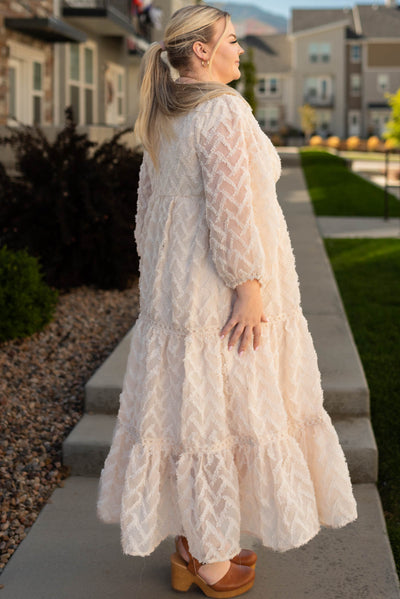 Side view of a plus size cream dress