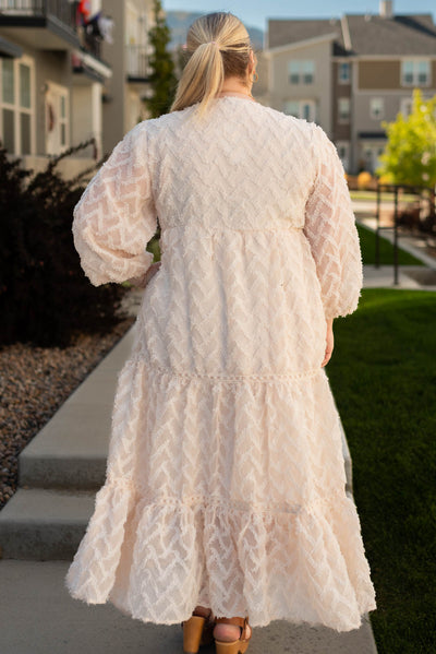 Back view of a plus size cream dress