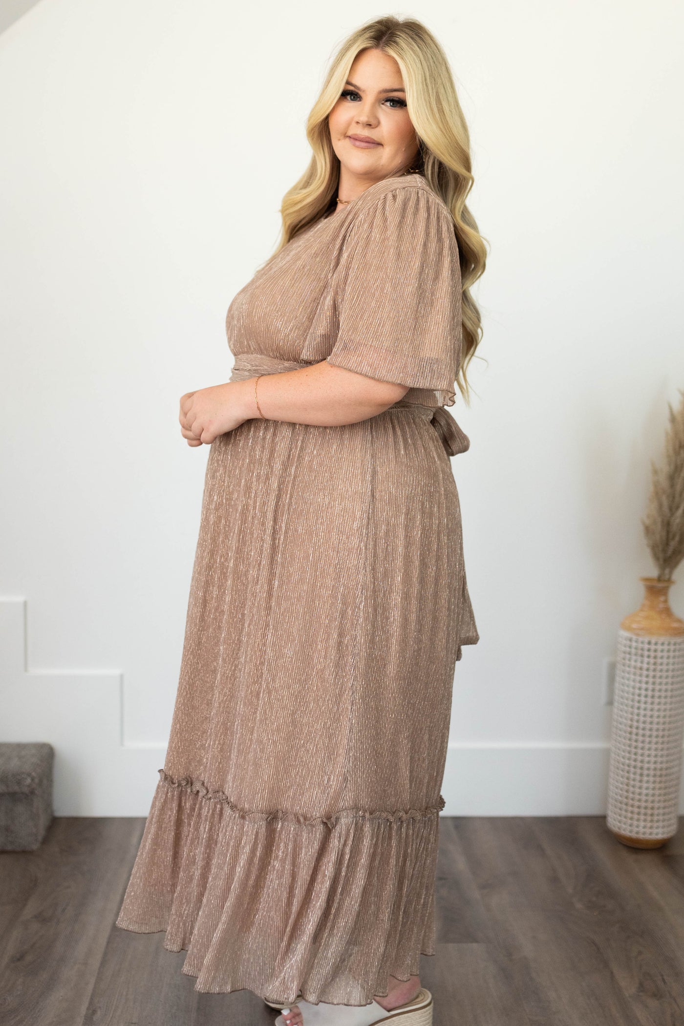 Side view of a plus size champagne dress