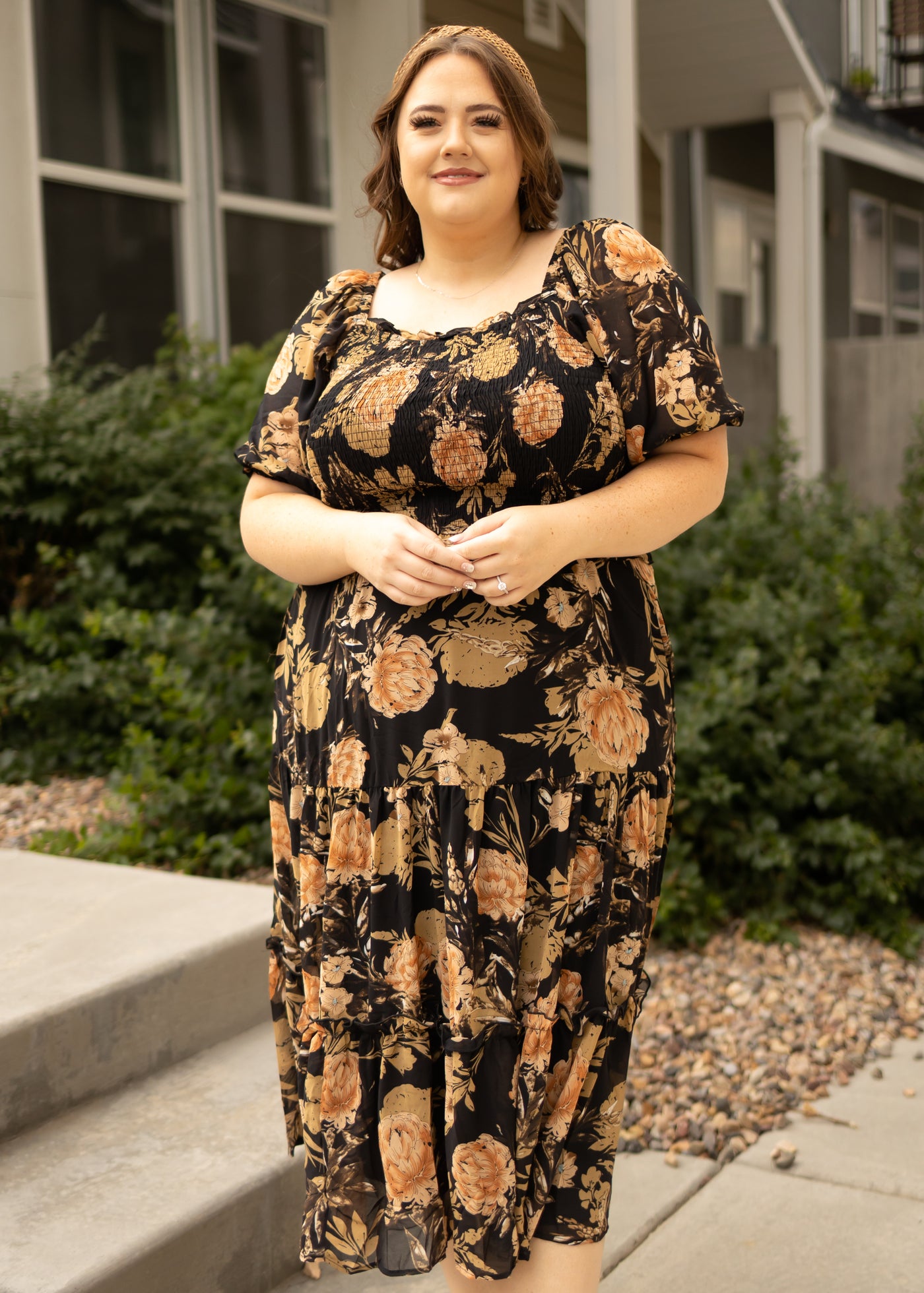 Plus size black floral dress with short sleeves and tiered skirt