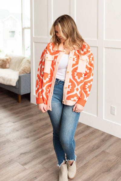 Orange Sherpa jacket with long sleeves and peach trim