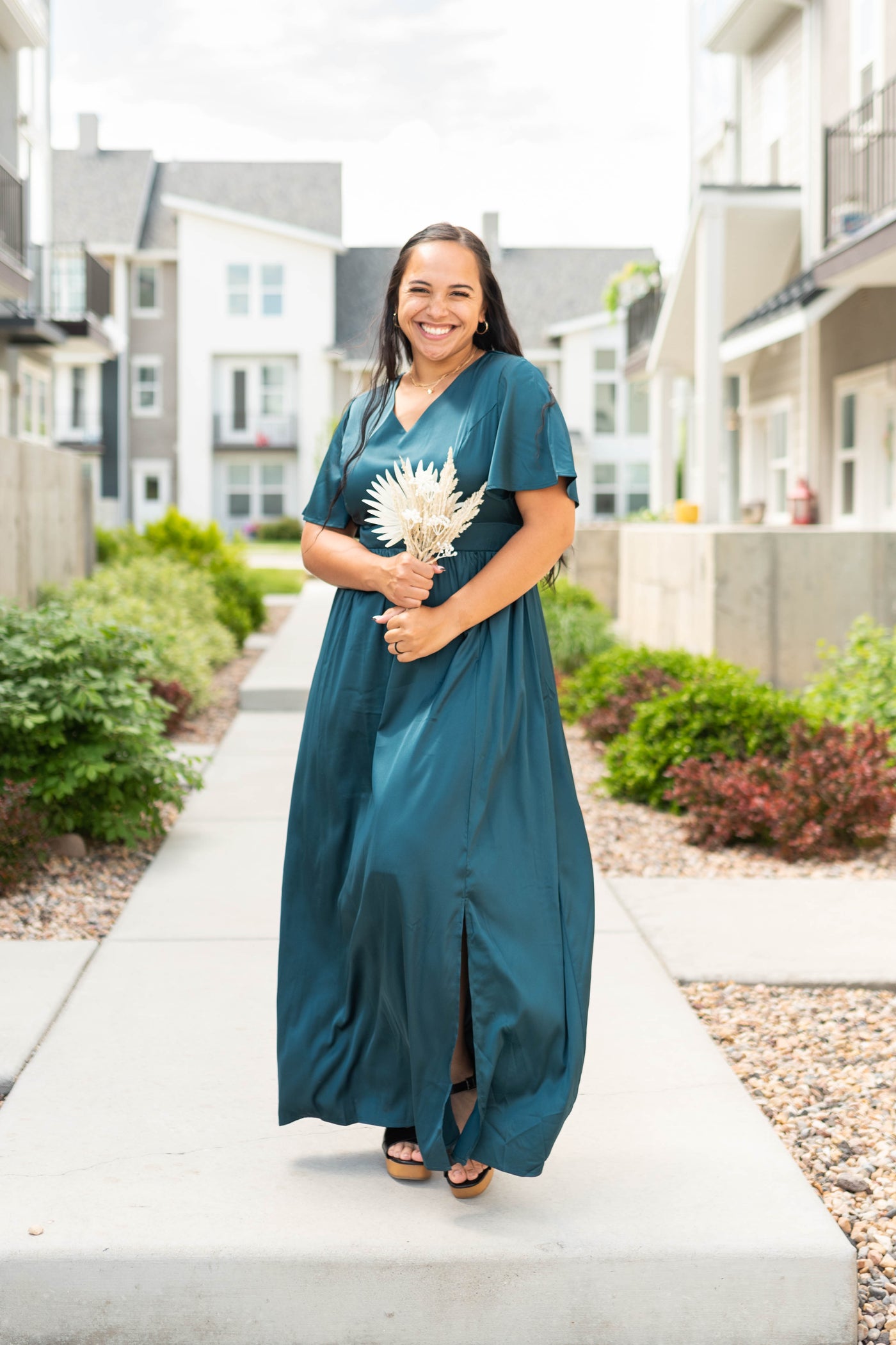 Sort sleeve deep teal dress with a slit on the side and a v-neck