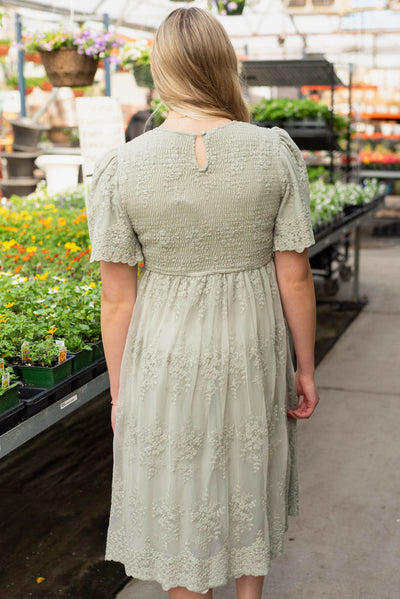 Back view of the sage embroidered dress