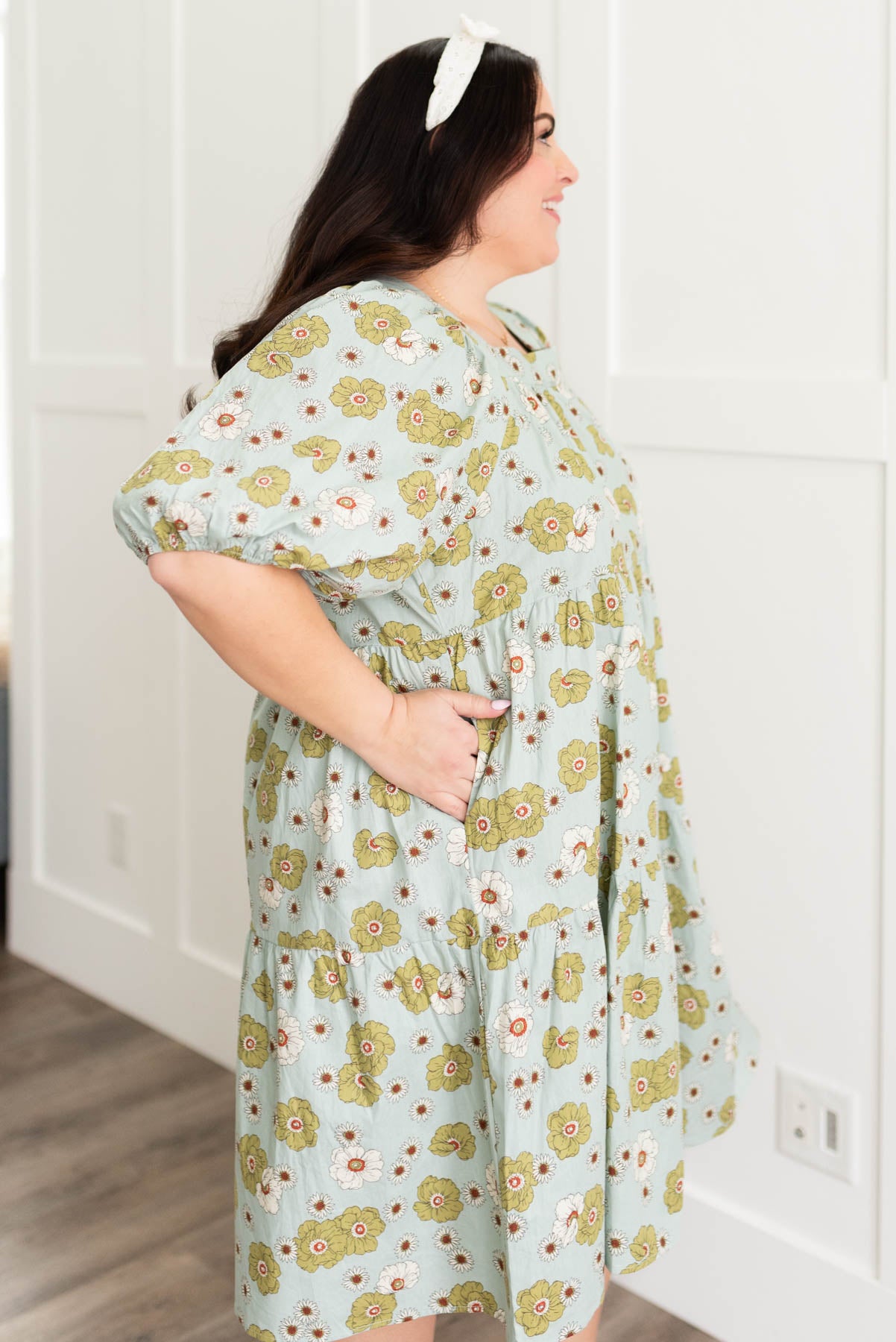 Side view of the plus size sage floral dress