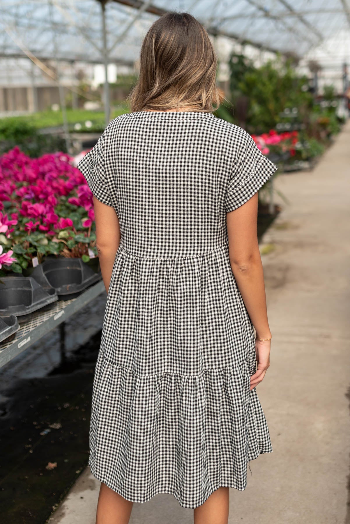 Back view of the black button down tiered dress