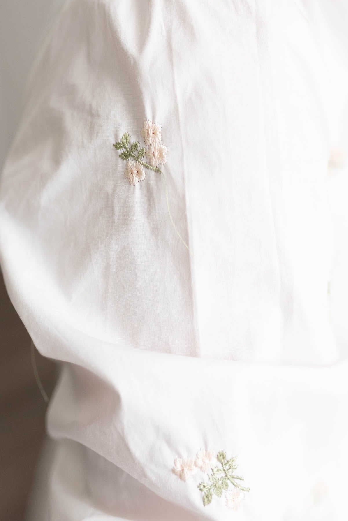 The embroidery on the ivory embroidered button down dress