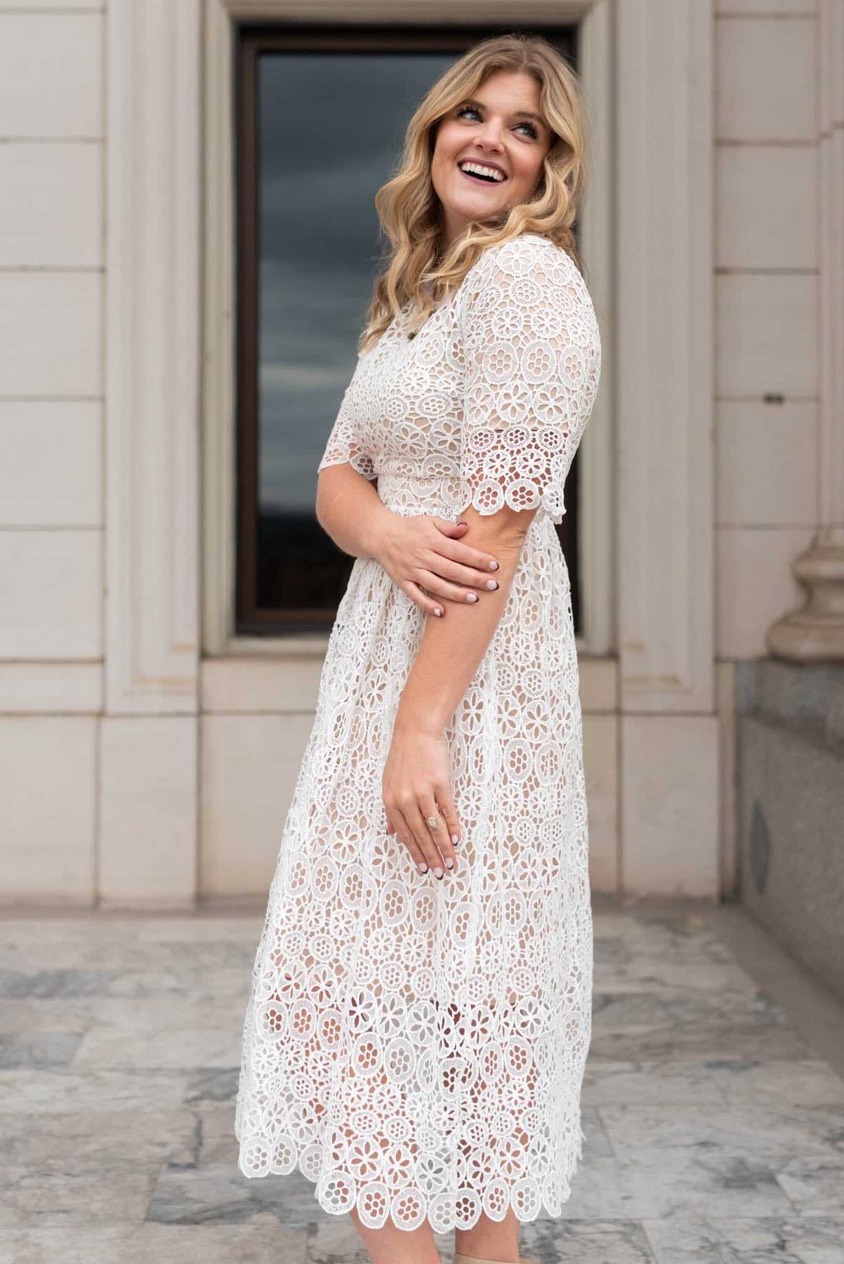 Side view of a short sleeve ivory lace dress
