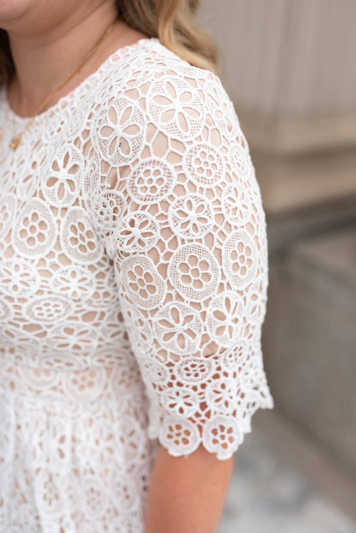 Close up of the lace fabric on a ivory lace dress