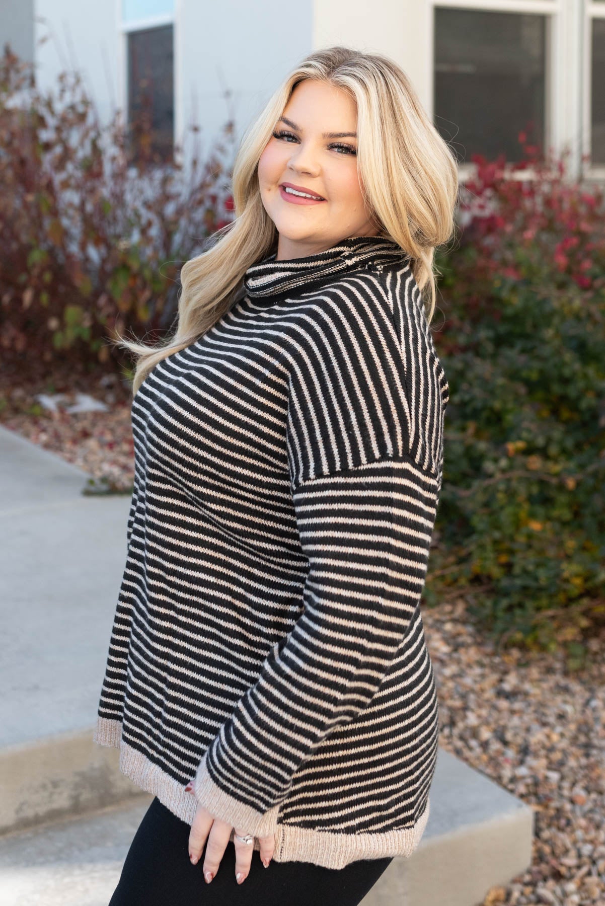 Side view of a plus size turtle neck sweater