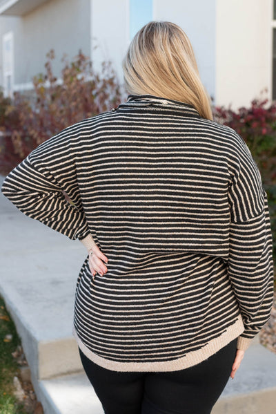 Back view of a plus size turtle neck sweater