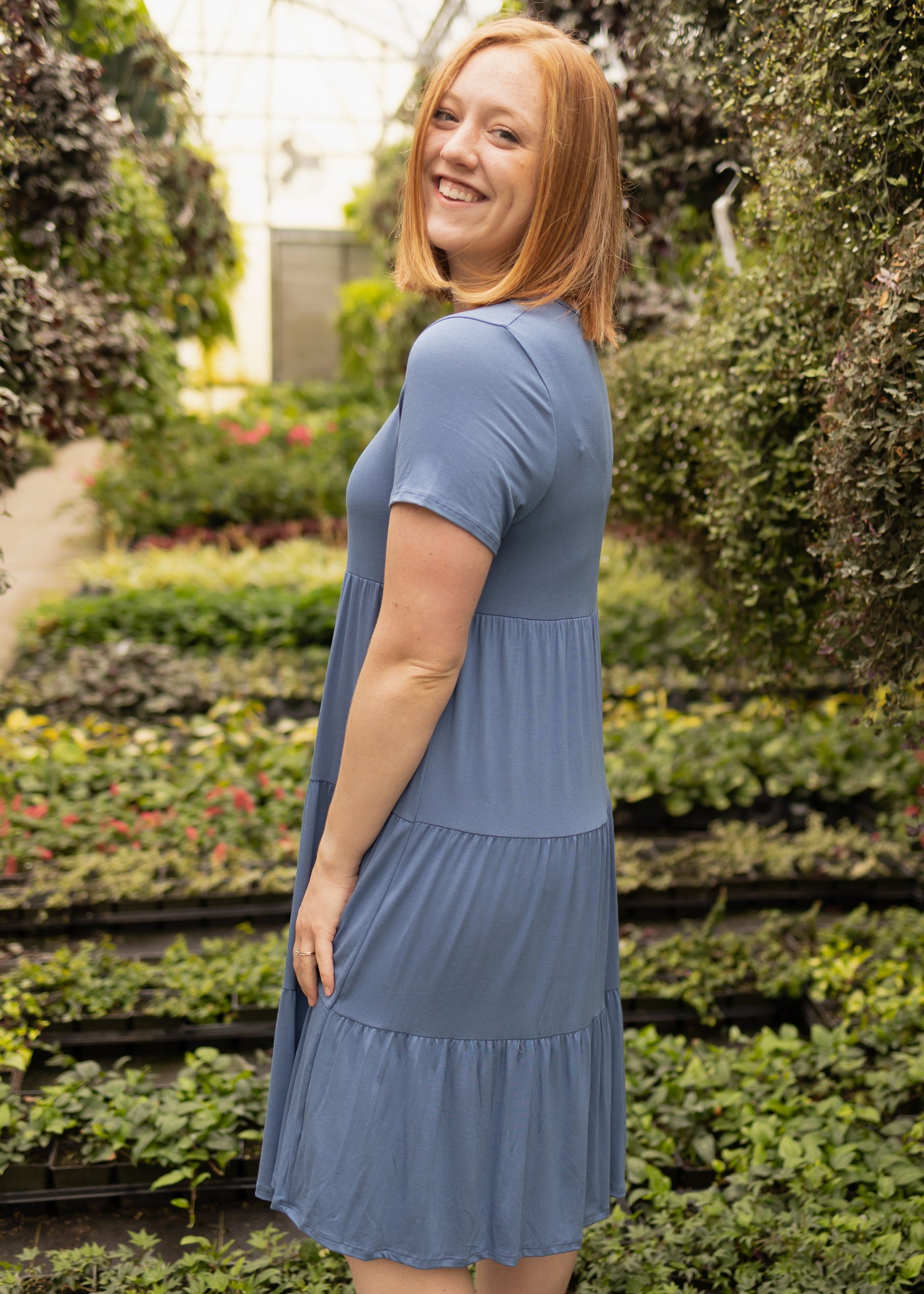 Side view of a medium short sleeve denim blue dress