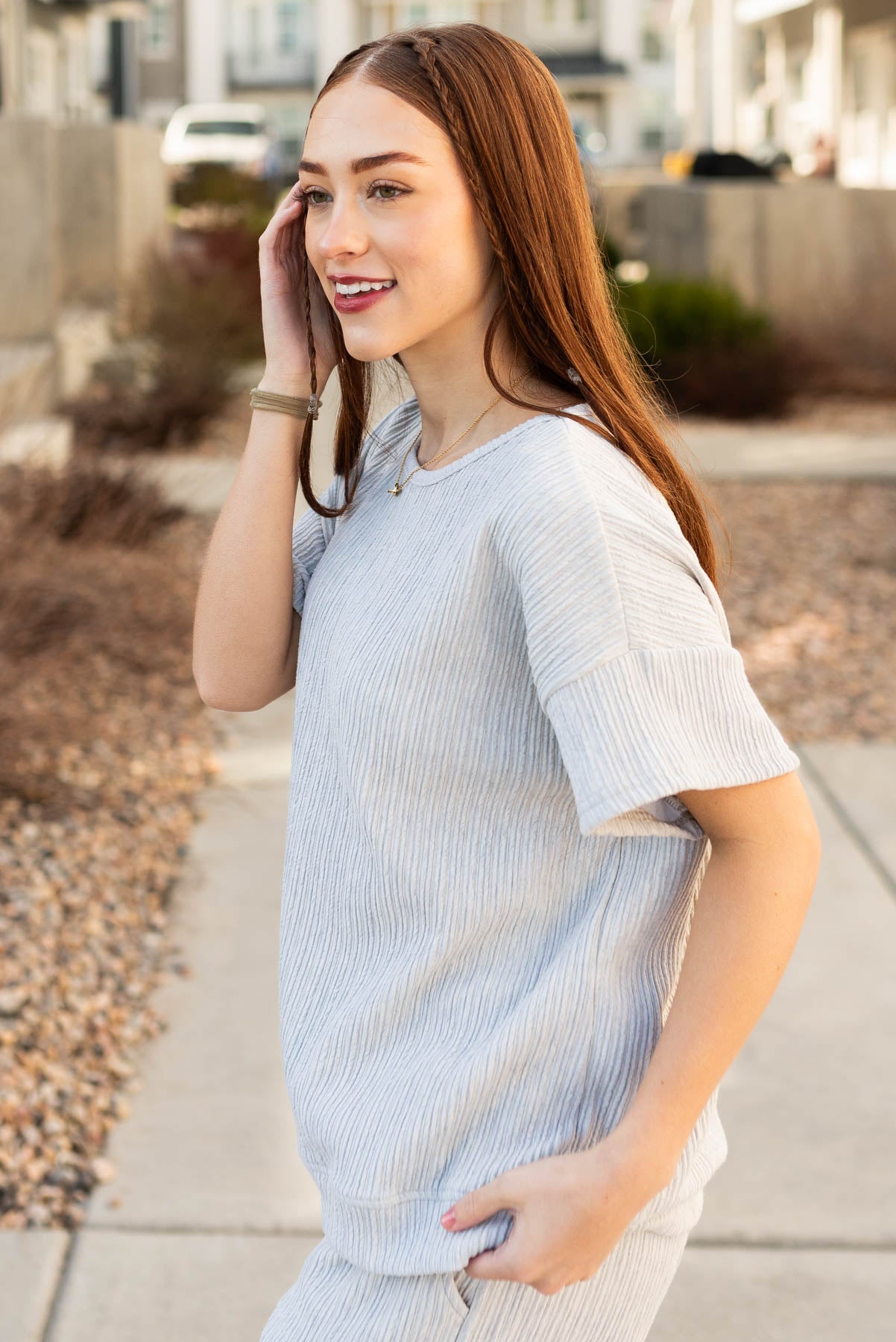 Side view of the sage grey textured top