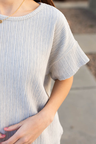 Close up of the fabric on the sage grey textured top