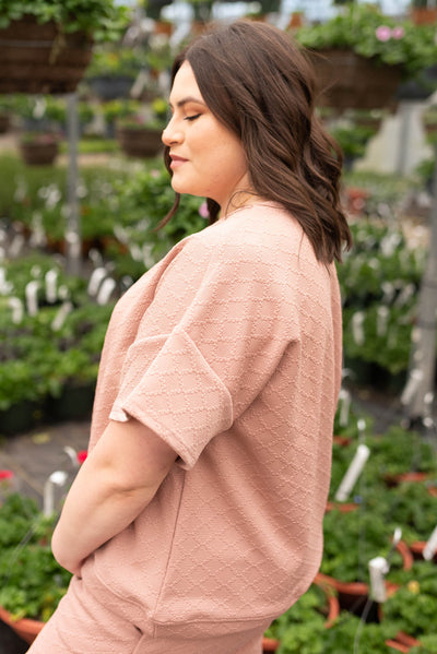 Side view of the plus size dusty pink textured top
