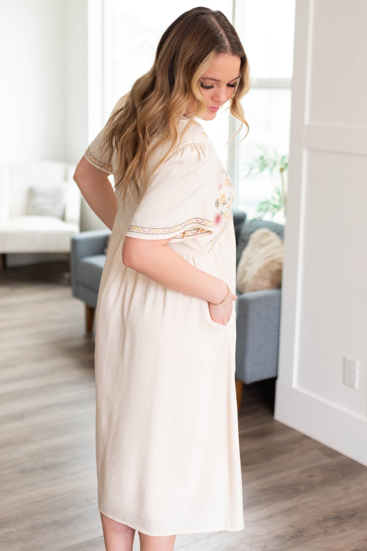 Side view of the cream embroidered dress