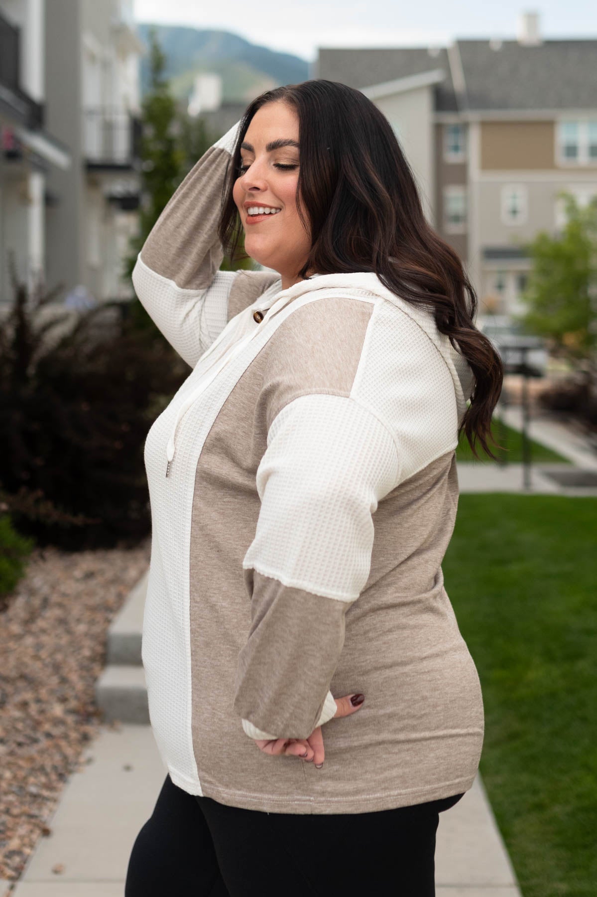 Side view of a plus size cream textured hoodie