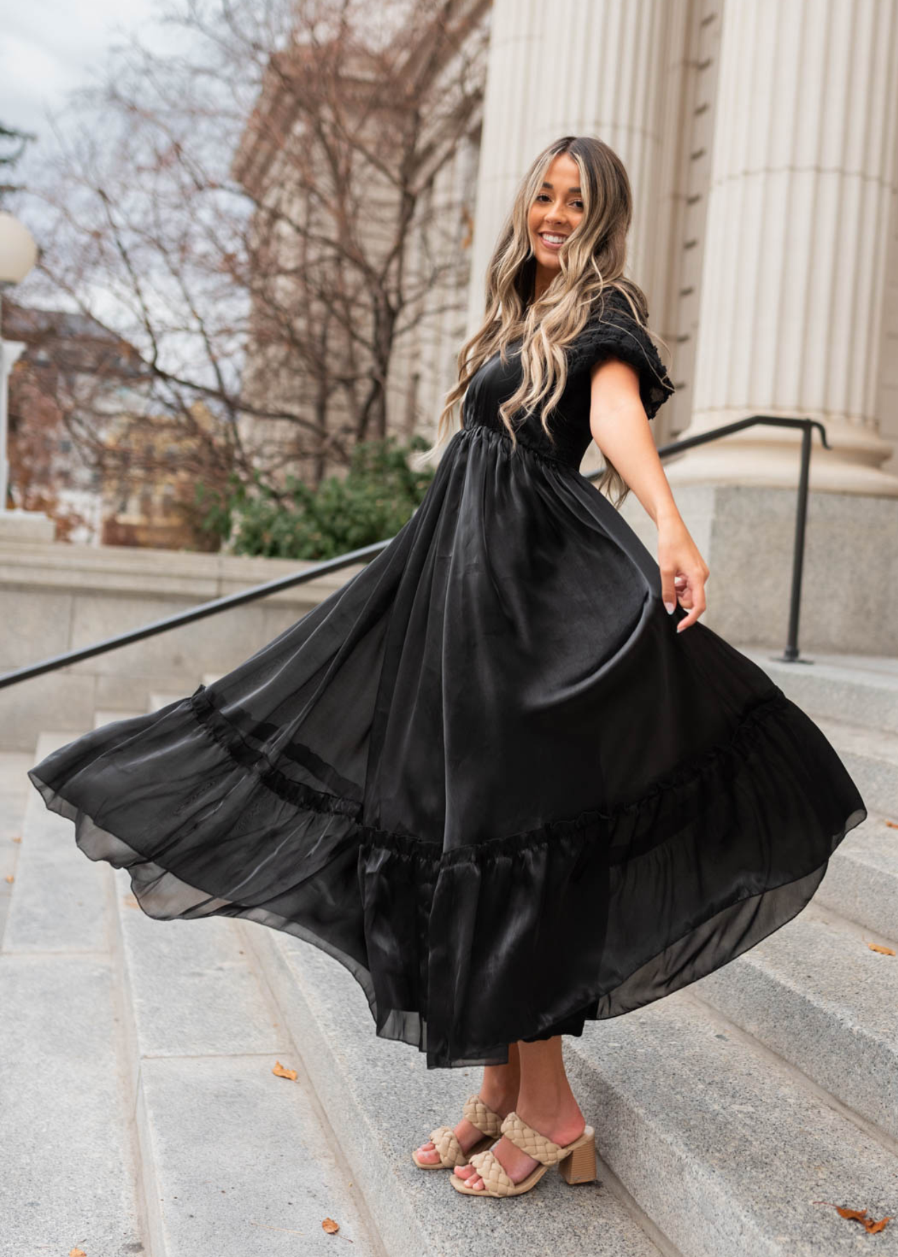 Side view of a short sleeve black organza dress