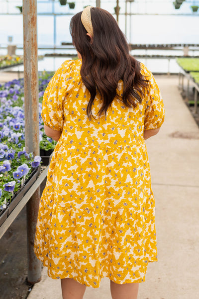 Back view of the plus size mustard floral dress