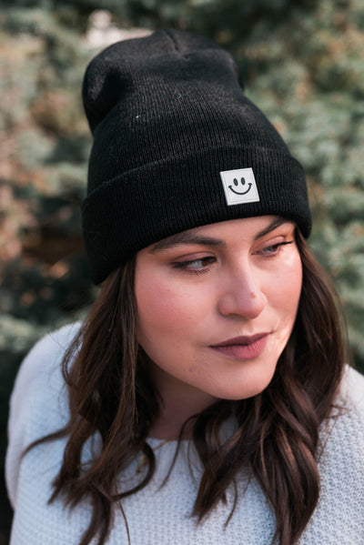 Front view of the black smiley beanie