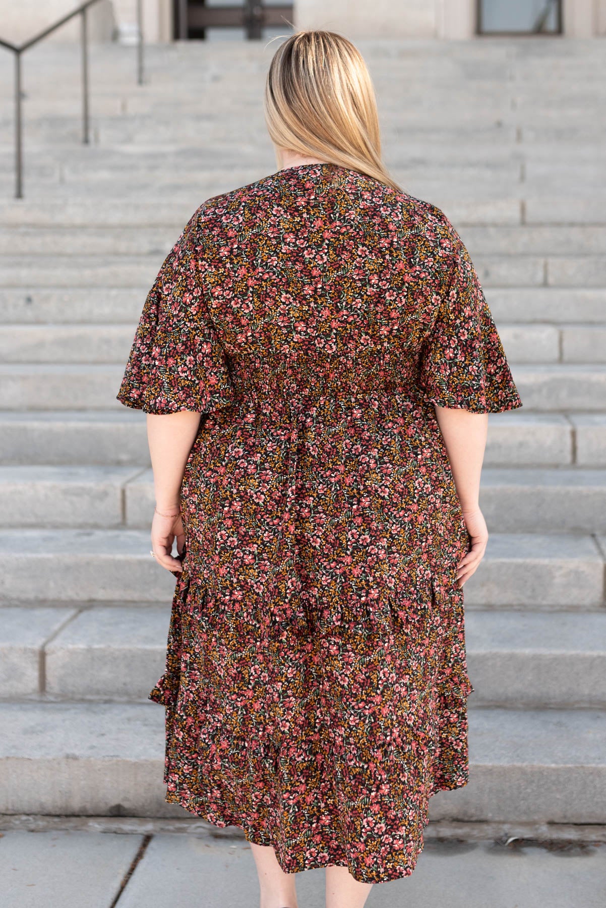 Back view of a plus size floral tiered ruffle dress