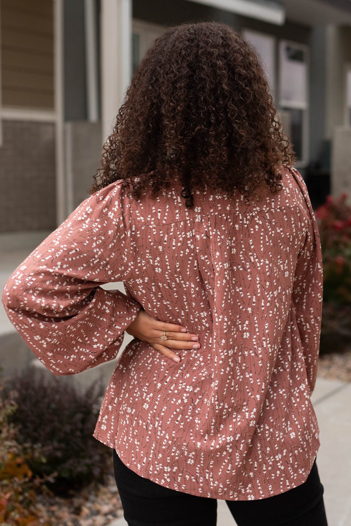 Back view of a marsala floral blouse
