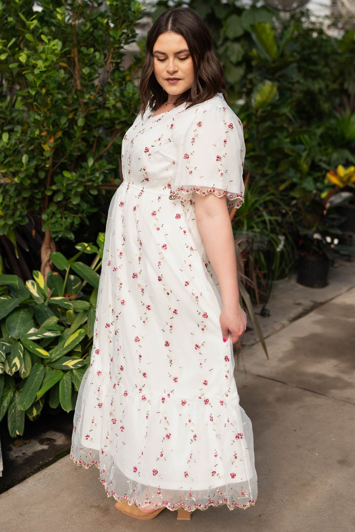Side view of the plus size ivory embroidered floral dress
