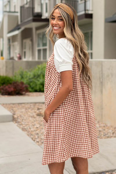 Side view of a cinnamon dress with pockets