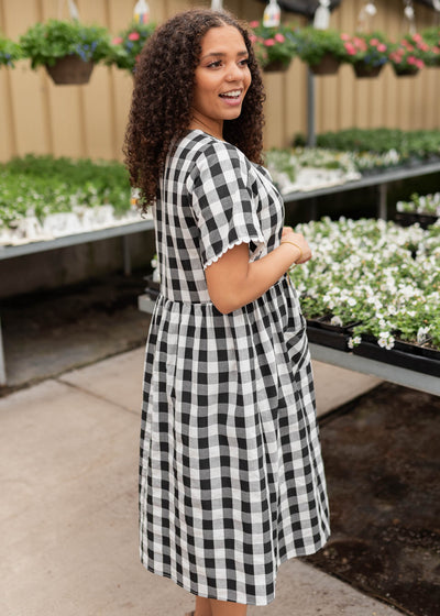 Side view of the black gingham button dress