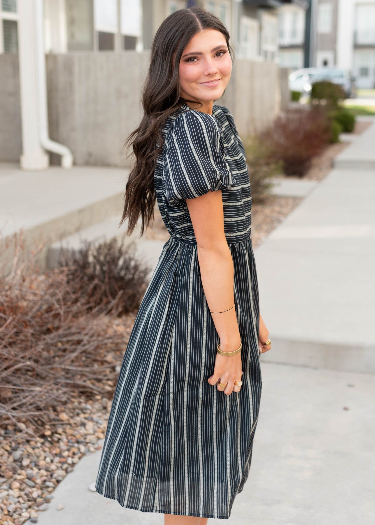 Side view of the navy jacquard stripe dress