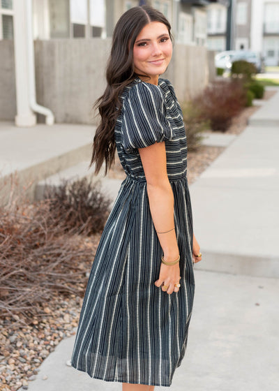 Side view of the navy jacquard stripe dress