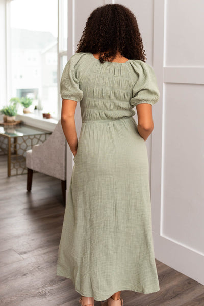Back view of a sage smocked dress