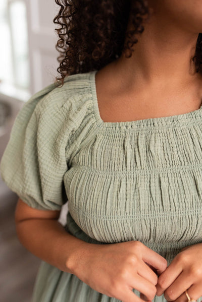 Close up of the smocking on a sage smocked dress