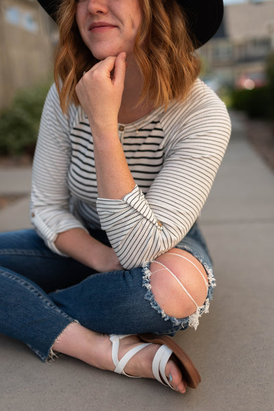 White stripe top with a cuff on a 3/4 sleeve