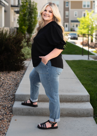 Short sleeve plus size black top with plus size medium wash jeans that are sold separately