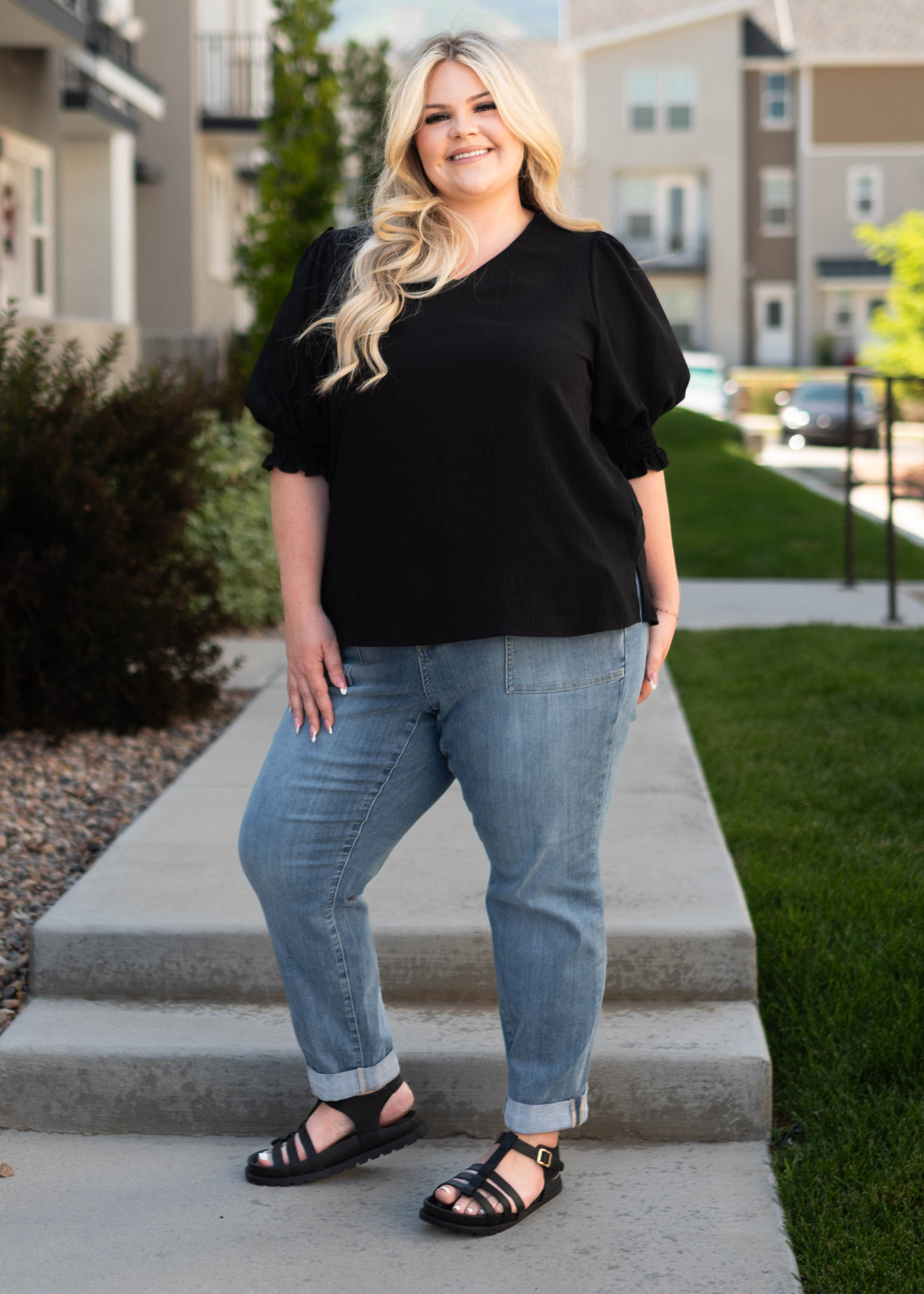 Plus size black top with medium wash jeans that are sold separately