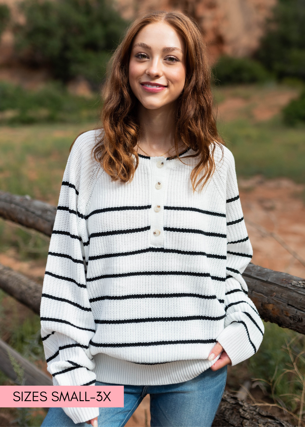 Ivory sweater with long sleeves, black stripes and buttons at the neck
