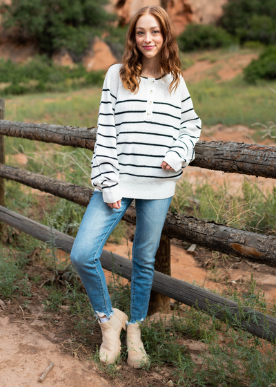 Ivory sweater with long sleeves and black stripes