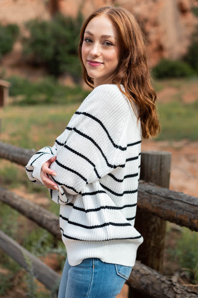 Side view of a ivory sweater