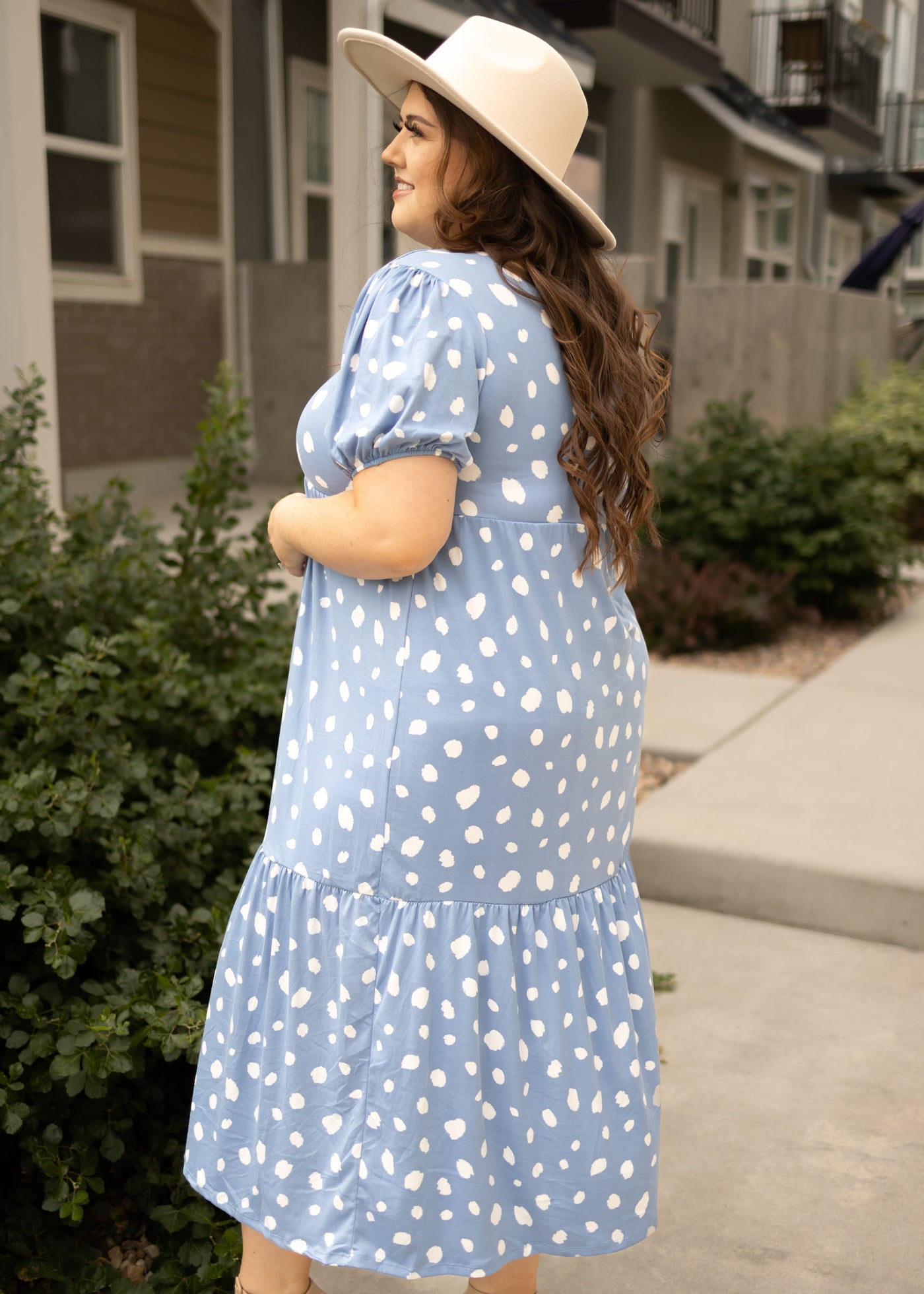 Side view of a plus size blue dress