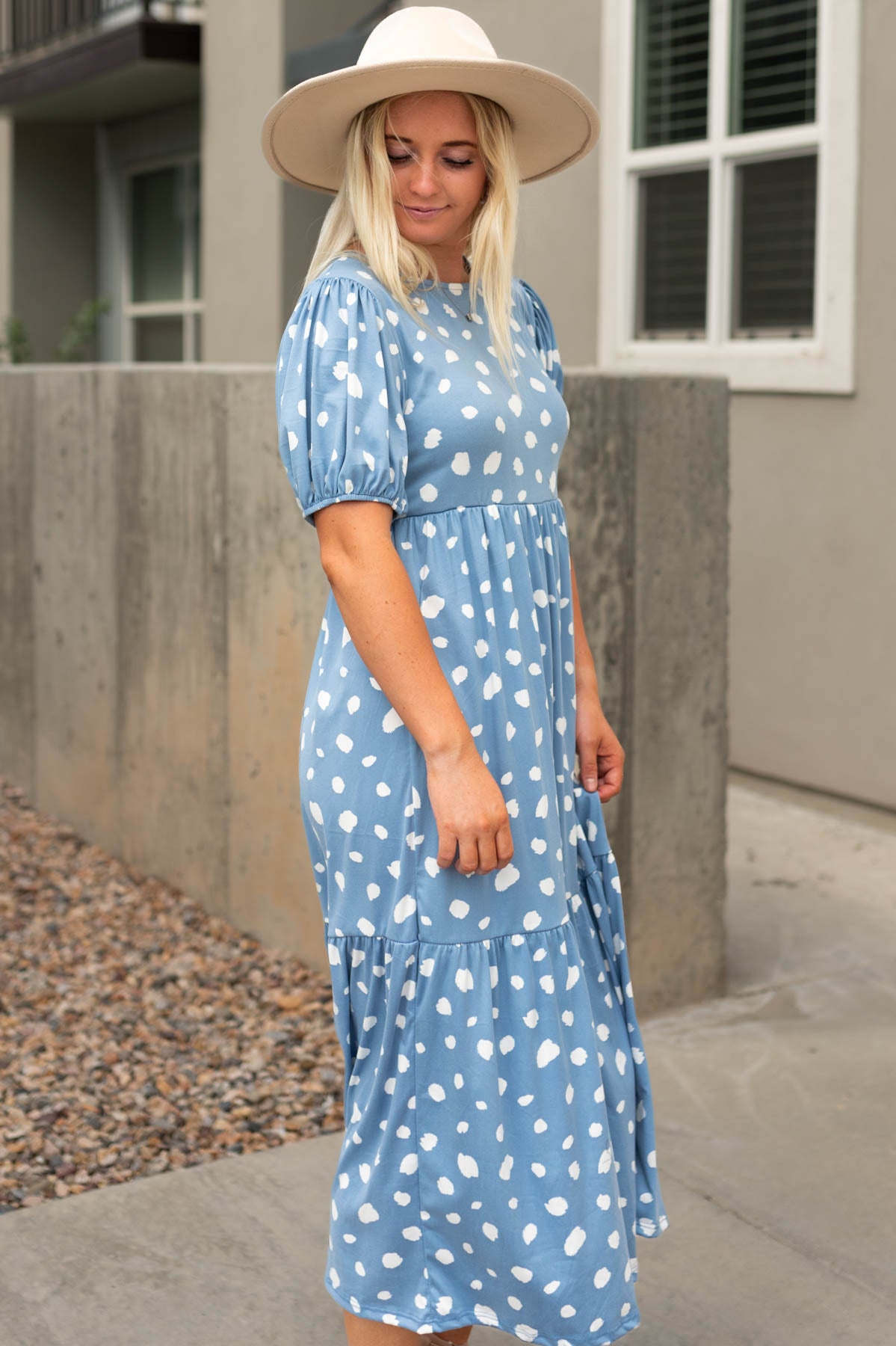 Side view of a short sleeve blue dress with tiered skirt